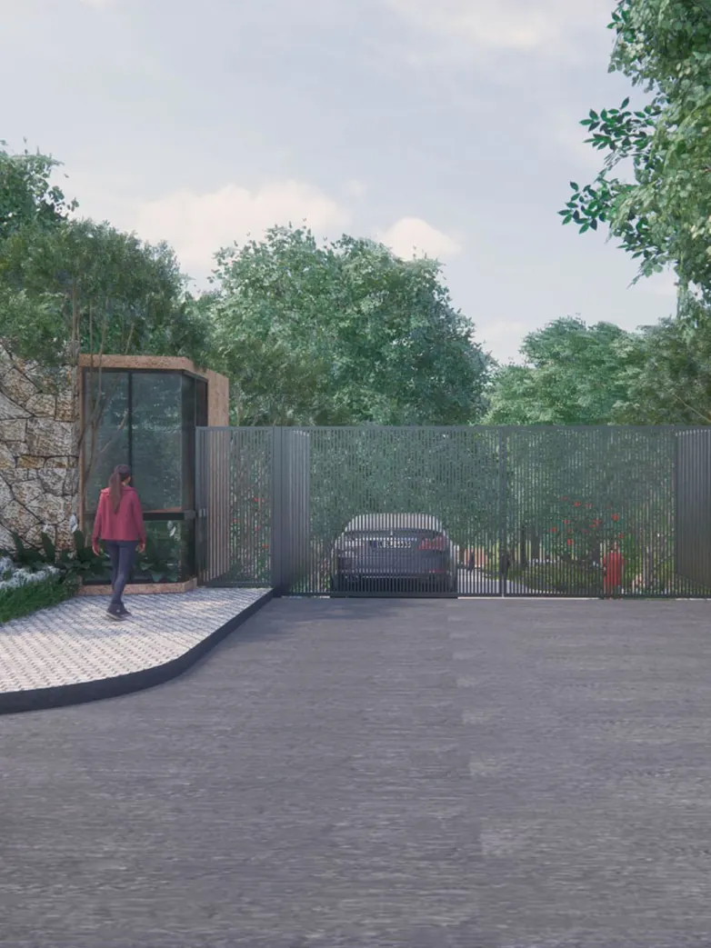 A gated entrance with a stone wall, a glass guard cabin and tall trees