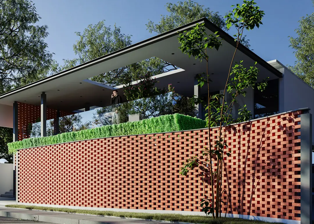 A two-level clubhouse with a red brick screen wall and a green roof terrace among trees